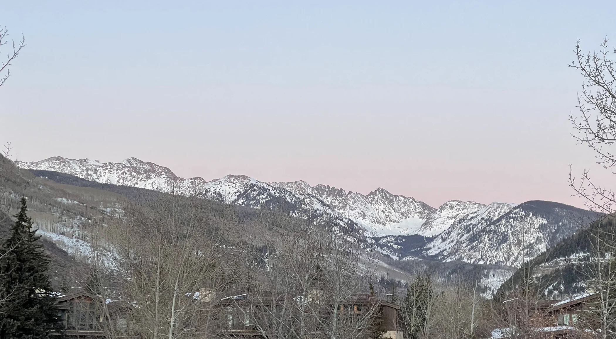 Snow-covered Gore Range peaks at magic hour, seen from Vail, Colorado.